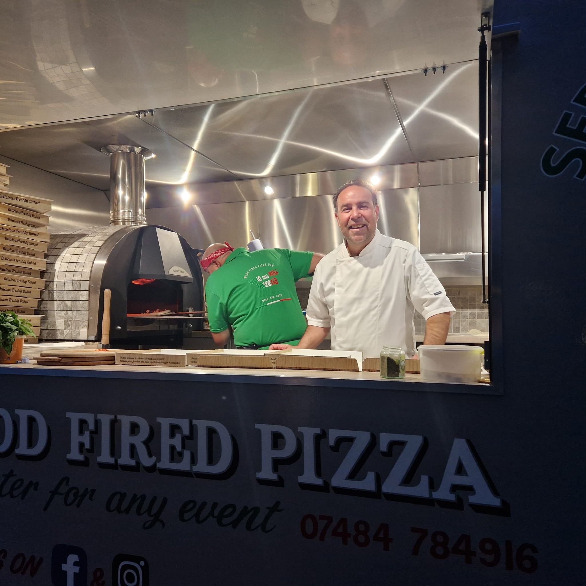 Sergio & Robi serving guests from the pizza van